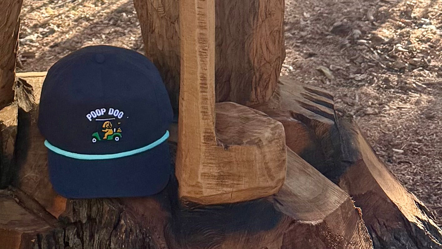 Navy blue cap with logo on a wooden surface
